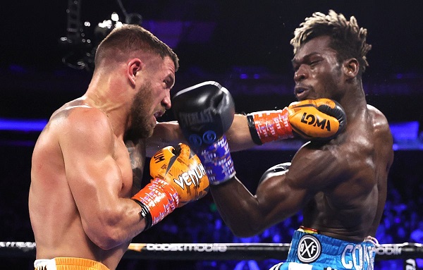  Flashback Lomachenko,(left) connects a left hook to the chin of commey in the bout in the US